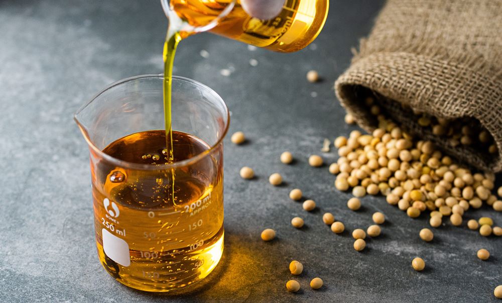 Degummed soybean oil poured into a laboratory beaker